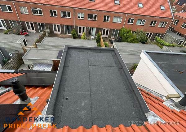 Plat dak met bitumen bedekking naast dakkapel in Prinsenbeek