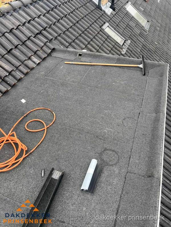 Plat dak reparatie met gereedschap en loodstroken in Prinsenbeek Plat dak reparatie met gereedschap en loodstroken in Prinsenbeek